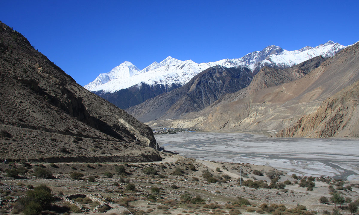 The Kali Gandaki river bed, the road to Tibet border and Muktinath with the mountains in the background.