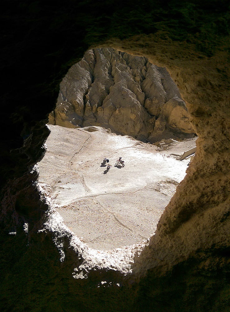 Looking down from the cockpit of the ancient sky caves Upper Mustang with Wild Tracks Nepal motorbike tours